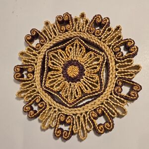 This charming vintage round trivet or hot pad is made of multicolor straw rattan